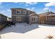 Spacious backyard with a patio, partially covered in snow, and a gray house in the background at 6211 Leilani Ln, Castle Rock, CO 80108