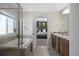 Bathroom with soaking tub, double vanity, and bedroom view at 6211 Leilani Ln, Castle Rock, CO 80108