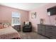 Charming bedroom with pink walls and a comfortable armchair at 6211 Leilani Ln, Castle Rock, CO 80108