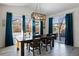 Bright dining room with a wooden table, teal curtains, and a view of the backyard at 6211 Leilani Ln, Castle Rock, CO 80108