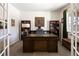 Well-lit home office with built-in shelves and a large desk at 6211 Leilani Ln, Castle Rock, CO 80108