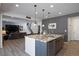 Kitchen island with granite countertop, sink, dishwasher and a view into the living room at 6211 Leilani Ln, Castle Rock, CO 80108