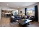 Open living room with a view into the kitchen, featuring two leather couches and a coffee table at 6211 Leilani Ln, Castle Rock, CO 80108