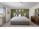 Main bedroom with large bed, green accent wall, and ample natural light at 6211 Leilani Ln, Castle Rock, CO 80108