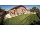 Landscaped backyard offers green grass, a small storage shed, and privacy fence at 12340 Syracuse St, Thornton, CO 80602