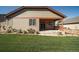 Backyard with covered patio, green lawn and plantings at 12340 Syracuse St, Thornton, CO 80602