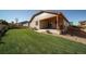 Well-manicured backyard featuring a lush lawn, covered patio, and lovely landscaping at 12340 Syracuse St, Thornton, CO 80602