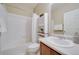 Clean bathroom showcasing a tub with shower, white tiled walls, and vanity with storage cabinet at 12340 Syracuse St, Thornton, CO 80602