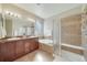 Relaxing bathroom with double vanity, soaking tub, and a separate shower with tiled walls and glass door at 12340 Syracuse St, Thornton, CO 80602