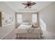 Bright bedroom featuring a tray ceiling, stylish fan, and cozy decor at 12340 Syracuse St, Thornton, CO 80602