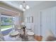 Bright dining area with stylish chandelier and access to the outdoors, perfect for gatherings and everyday meals at 12340 Syracuse St, Thornton, CO 80602