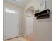 Welcoming entryway with a front door, shelf with coat hooks, and neutral color scheme for a modern look at 12340 Syracuse St, Thornton, CO 80602