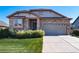 Charming single-Gathering home featuring a stone facade, two-car garage, and well-maintained landscaping at 12340 Syracuse St, Thornton, CO 80602