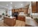 Bright kitchen features a center island, stainless steel appliances, and hardwood floors, making it an ideal gathering place at 12340 Syracuse St, Thornton, CO 80602