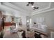 Spacious living room with an open concept, ceiling fan, and an easy transition to the kitchen and dining area at 12340 Syracuse St, Thornton, CO 80602