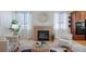 Inviting living room featuring a fireplace, a decorative mirror, and comfortable seating for relaxation at 12340 Syracuse St, Thornton, CO 80602