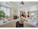 Bright living room featuring a fireplace, modern furnishings, and an open layout connected to the kitchen at 12340 Syracuse St, Thornton, CO 80602
