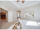 Inviting primary bedroom with tray ceiling and neutral decor, leading to ensuite bathroom at 12340 Syracuse St, Thornton, CO 80602