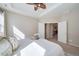 Light-filled main bedroom with a tray ceiling, ceiling fan, and a glimpse into the living room at 12340 Syracuse St, Thornton, CO 80602