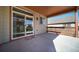 Covered patio with wood railing and sliding door access to the home at 12340 Syracuse St, Thornton, CO 80602