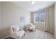 A cozy sitting room with two chairs, natural lighting, and a neutral color scheme at 12340 Syracuse St, Thornton, CO 80602