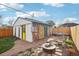 Backyard featuring a stone patio, fire pit, and garage with a mural at 4883 Perry St, Denver, CO 80212