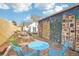 Charming backyard with a patio, fire pit, mural, and lush landscaping. Great for entertaining at 4883 Perry St, Denver, CO 80212