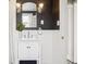 Stylish bathroom with a white vanity, modern fixtures, and a framed mirror with sconces against black accent wall at 4883 Perry St, Denver, CO 80212