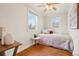 Inviting bedroom with hardwood floors, a comfortable bed, and natural light from the windows at 4883 Perry St, Denver, CO 80212