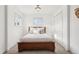 Cozy bedroom featuring a wood bed frame, white walls, and natural light from two windows at 4883 Perry St, Denver, CO 80212
