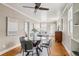 Spacious dining room with hardwood floors, a modern table, and easy access to the living room and kitchen at 4883 Perry St, Denver, CO 80212