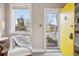 Bright entryway with a sunny yellow door and classic trim at 4883 Perry St, Denver, CO 80212