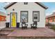 Inviting front porch with comfortable seating and a bright yellow door at 4883 Perry St, Denver, CO 80212