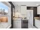 Modern kitchen features granite countertops, white cabinets, and stylish flooring, creating a functional and elegant space at 4883 Perry St, Denver, CO 80212