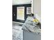Close up of kitchen with granite countertop and sink overlooking a window at 4883 Perry St, Denver, CO 80212