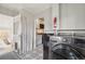 Bright laundry room with gray appliances and white cabinets featuring direct access to the sunroom at 4883 Perry St, Denver, CO 80212
