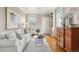 Comfortable living room features hardwood floors, a white sofa, and built-in shelving, providing a relaxing atmosphere at 4883 Perry St, Denver, CO 80212