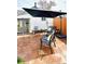 Back patio area with flagstone pavers, comfortable seating, and modern shade umbrella at 4883 Perry St, Denver, CO 80212