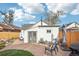Relaxing back patio area featuring comfortable seating, flagstone pavers, and outdoor grill at 4883 Perry St, Denver, CO 80212