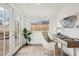 A sunroom features a large window and French door with a desk and tile floors at 4883 Perry St, Denver, CO 80212