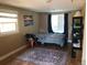 Comfortable bedroom featuring two windows, a patterned rug, and simple decor for a cozy retreat at 1925 Joliet St, Aurora, CO 80010