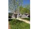 Charming single-story home with gray siding, a well-manicured lawn, and a welcoming walkway at 1925 Joliet St, Aurora, CO 80010