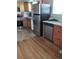 Functional kitchen featuring stainless steel appliances, a mix of wooden and tile flooring, and granite countertops at 1925 Joliet St, Aurora, CO 80010