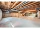 Unfinished basement featuring exposed beams, concrete floor, and visible utilities, ready for customization at 2056 S Newark Way, Aurora, CO 80014