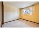 Bedroom with wallpaper, carpeted floors, and a window at 2056 S Newark Way, Aurora, CO 80014