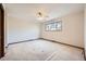 Spacious bedroom with neutral carpet, ceiling fan and a window overlooking the yard at 2056 S Newark Way, Aurora, CO 80014