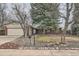 Inviting single-story brick home with a manicured front yard and mature trees at 2056 S Newark Way, Aurora, CO 80014