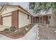 Attractive brick home with an attached garage and a landscaped front walkway at 2056 S Newark Way, Aurora, CO 80014