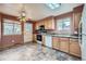 Functional kitchen with light wood cabinets, a skylight, and a ceiling fan at 2056 S Newark Way, Aurora, CO 80014