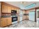 Bright kitchen features wood cabinets, black appliances, and neutral countertops at 2056 S Newark Way, Aurora, CO 80014